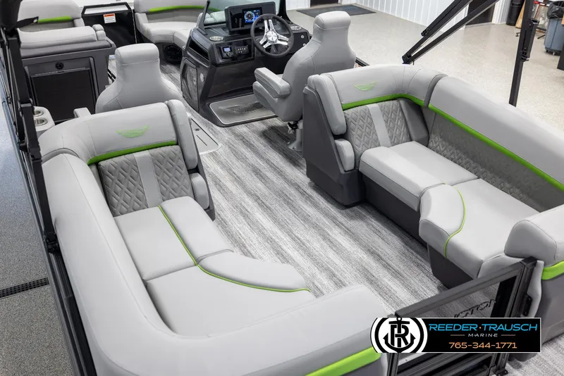 Slide: The Image of 2025 Bennington MFBSE boat interior with gray and green seating, modern dashboard, and carpeted flooring. - 11
