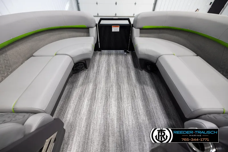 Slide: The Image of 2025 Bennington MFBSE boat interior with gray seating and green accents. - 18