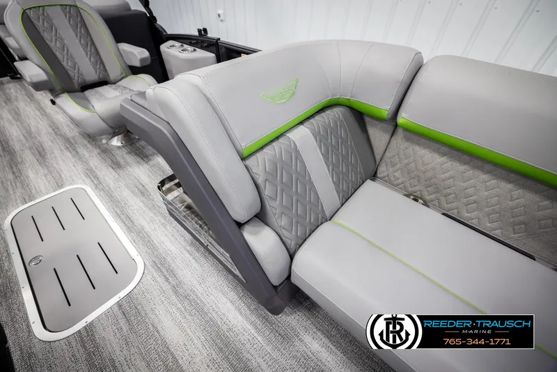 Slide: The Image of 2025 Bennington MFBSE boat interior with gray and green seating, featuring diamond stitching. - 20