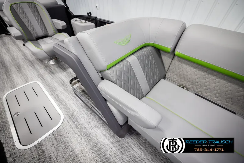 Slide: The Image of 2025 Bennington MFBSE boat interior with gray and green seating, modern design, and logo detail. - 21