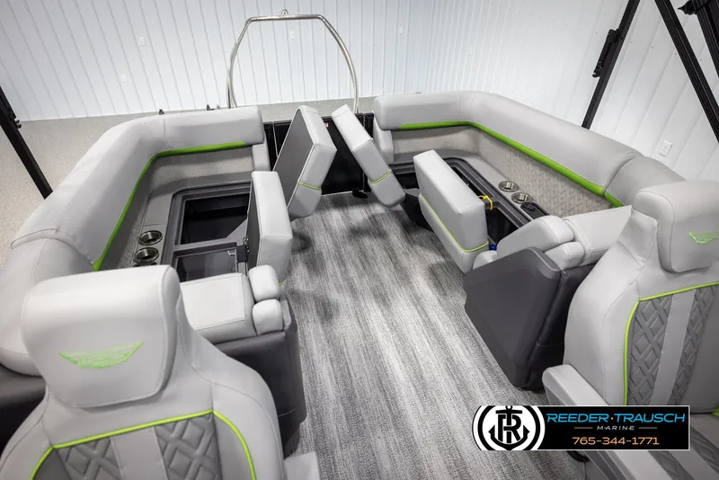 Slide: The Image of 2025 Bennington MFBSE boat interior with gray seating and green accents, featuring cup holders and storage. - 26