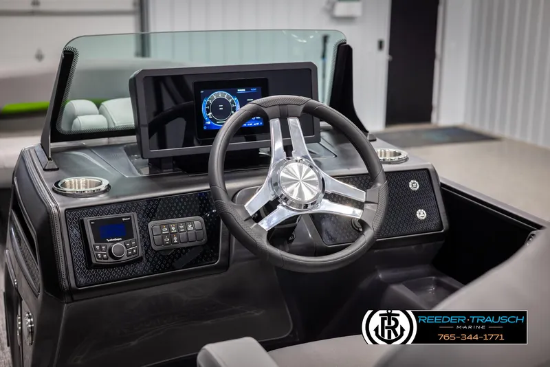Slide: The Image of 2025 Bennington MFBSE boat dashboard with modern steering wheel and digital display. - 28