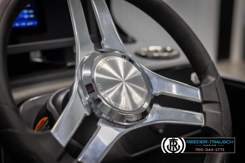 Slide: The Image of Steering wheel of 2025 Bennington MFBSE boat, featuring sleek metallic design. - 29