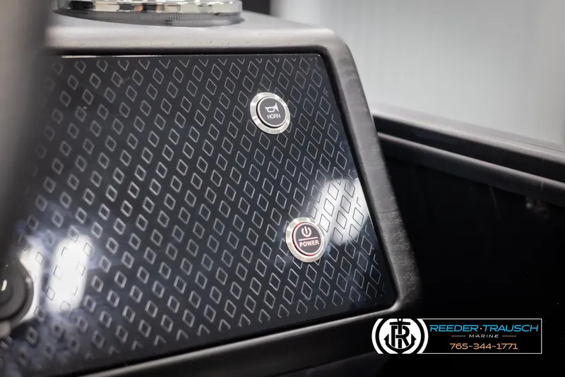 Slide: The Image of Dashboard of 2025 Bennington MFBSE with power and horn buttons, Reeder-Trausch Marine logo. - 33