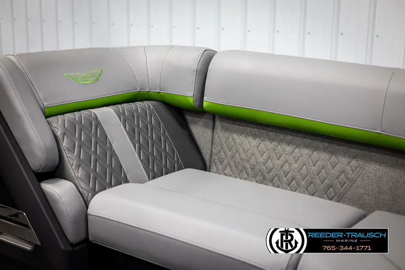 Slide: The Image of 2025 Bennington MFBSE boat interior with gray and green upholstery, diamond stitching. - 42