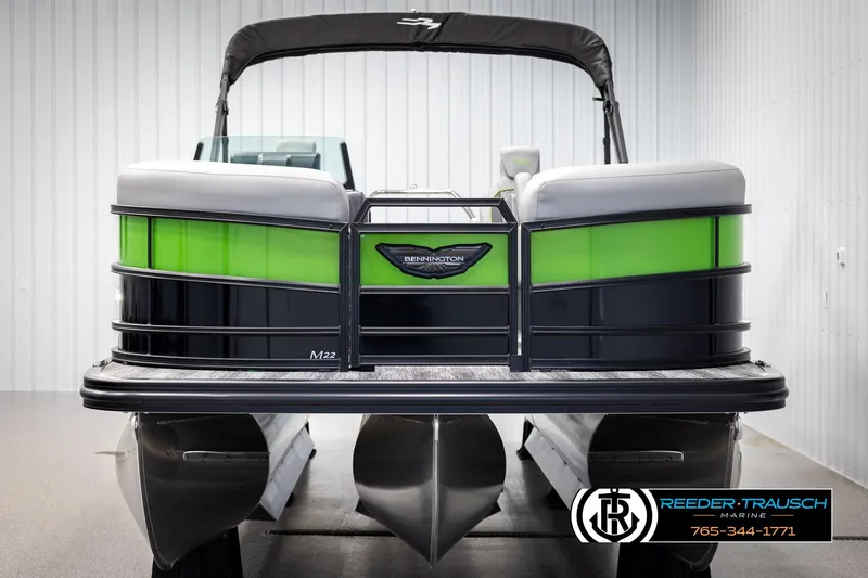 Slide: The Image of 2025 Bennington MFBSE pontoon boat with green and black accents, displayed indoors. - 8
