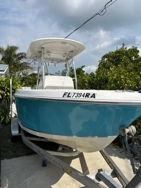 The Image of 2016 Release 208 RX boat on trailer, blue hull, parked outdoors. - 0