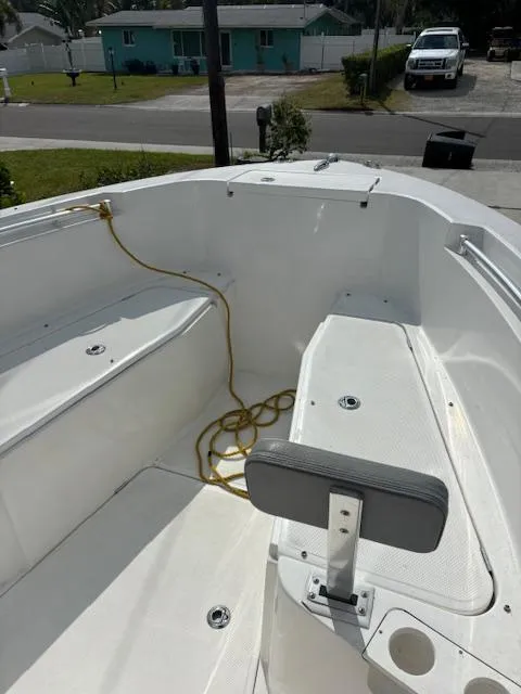 Slide: The Image of 2016 Release 208 RX boat interior with seating and rope, parked in a residential area. - 15