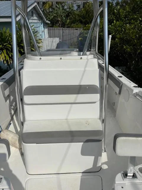 Slide: The Image of 2016 Release 208 RX boat interior with seating and railing, surrounded by greenery. - 16