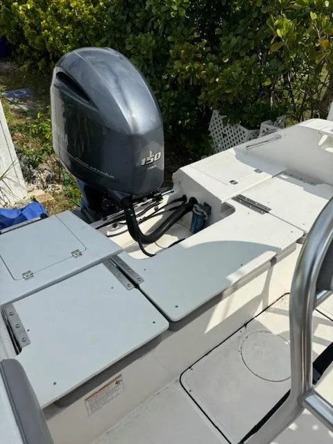 Slide: The Image of 2016 Release 208 RX boat with Yamaha 150 outboard motor, docked near greenery. - 18