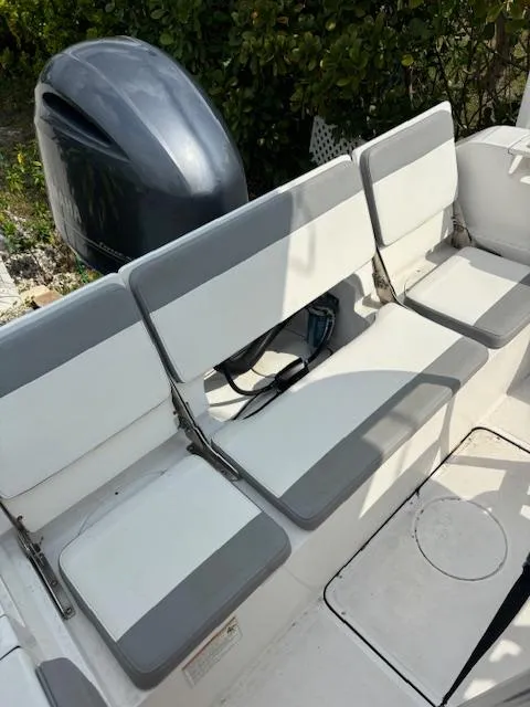 Slide: The Image of White and gray seating on a 2016 Release 208 RX boat with an outboard motor. - 19