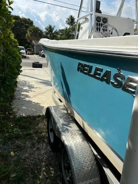 Slide: The Image of 2016 Release 208 RX boat on trailer, blue hull, parked outdoors. - 2