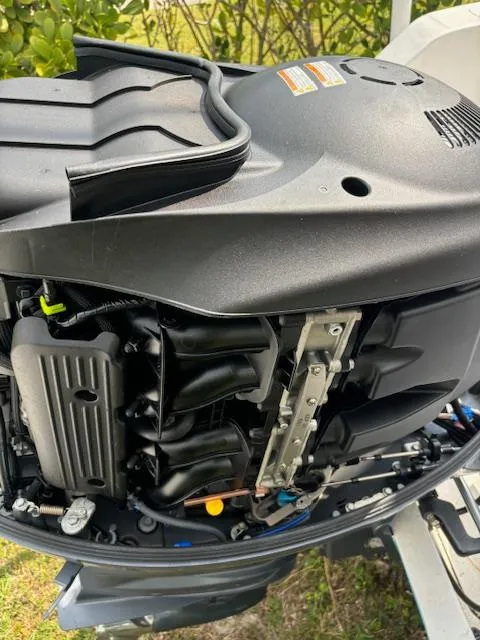 Slide: The Image of Close-up of a 2016 Release 208 RX boat engine, showcasing intricate mechanical components. - 25