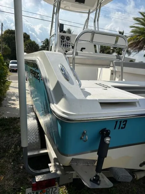 Slide: The Image of 2016 Release 208 RX boat with blue and white exterior on a trailer. - 3