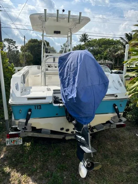 Slide: The Image of 2016 Release 208 RX boat with covered motor, parked on grass. - 4