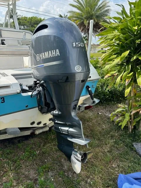 Slide: The Image of 2016 Release 208 RX boat with Yamaha 150 outboard motor, parked outdoors. - 5