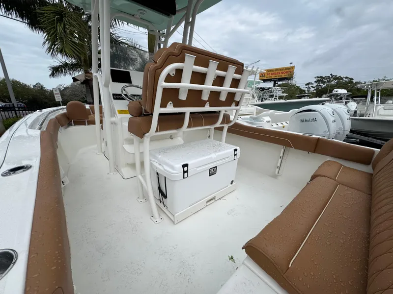 Slide: The Image of 2025 Key West 219 FS boat interior with tan seating and a white cooler. - 13