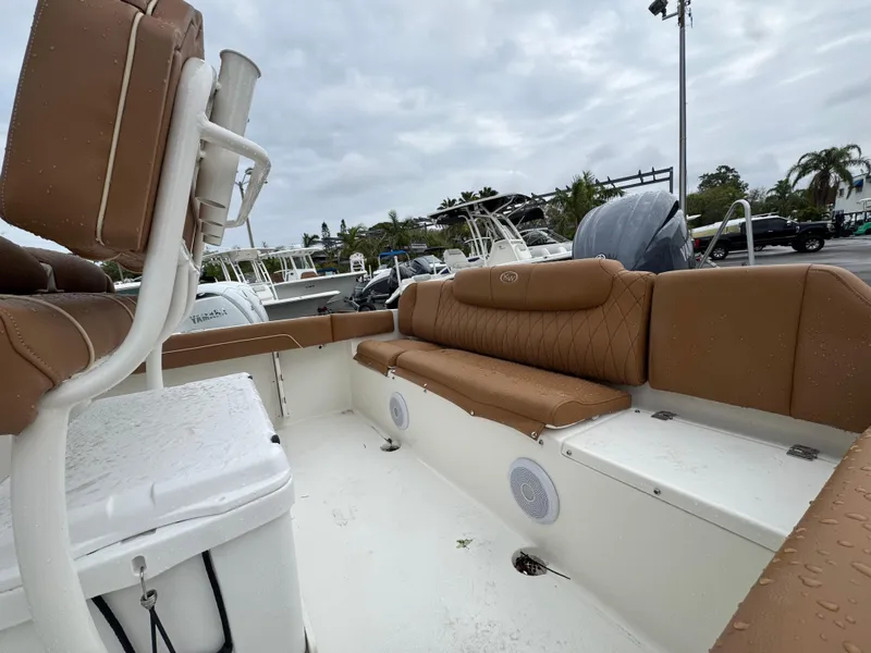 Slide: The Image of 2025 Key West 219 FS boat interior with tan seating and white deck. - 15