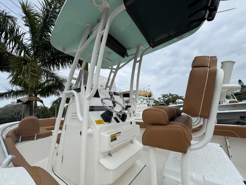 Slide: The Image of 2025 Key West 219 FS boat with brown seating and modern console. - 16