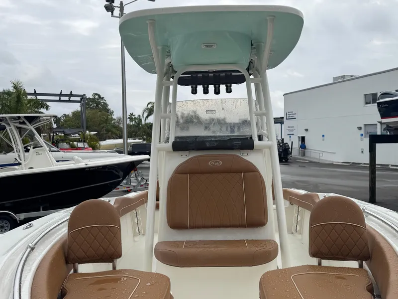 Slide: The Image of 2025 Key West 219 FS boat with brown seating, docked outdoors. - 22