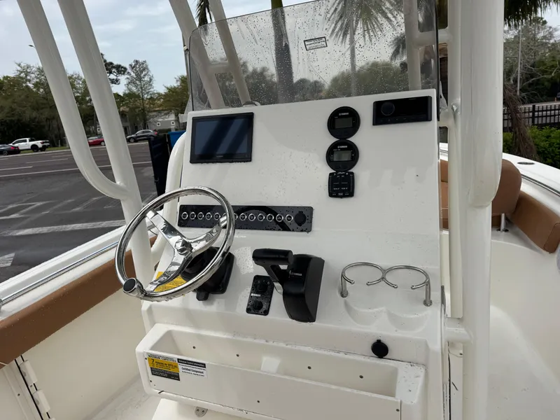 Slide: The Image of 2025 Key West 219 FS boat console with steering wheel, controls, and display gauges. - 26