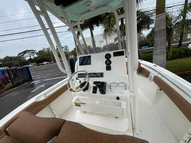 Slide: The Image of 2025 Key West 219 FS boat interior with steering console and seating. - 27