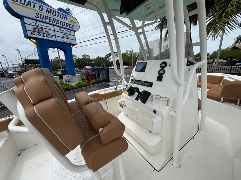 Slide: The Image of 2025 Key West 219 FS boat interior with brown seating at dealership. - 28