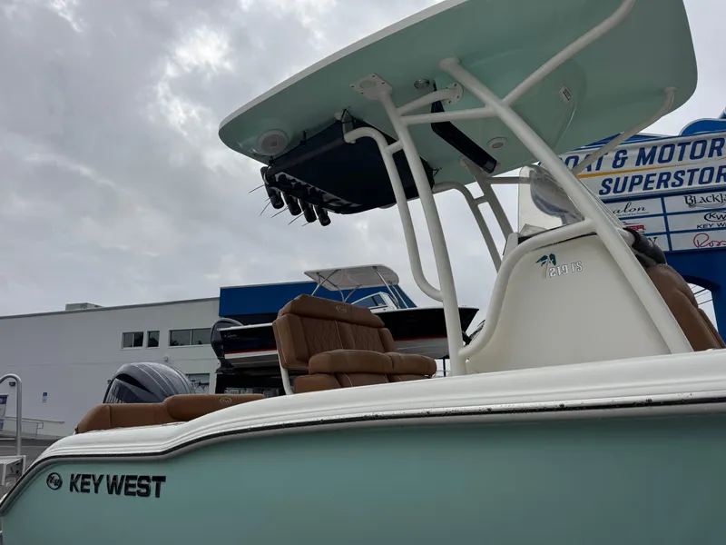 Slide: The Image of 2025 Key West 219 FS boat with T-top and seating, displayed outdoors. - 5