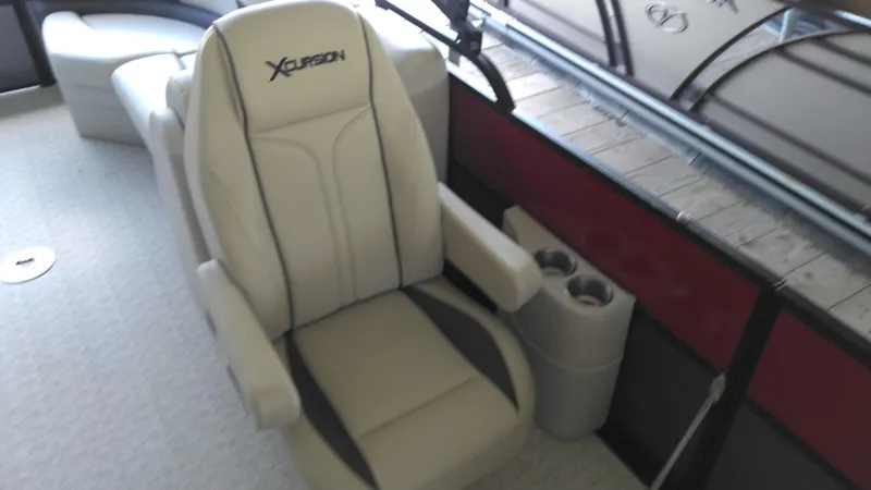 Slide: The Image of 2022 Xcursion 243RFX boat seat with cup holders, beige and gray upholstery. - 14