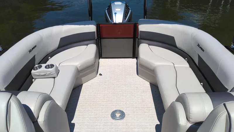 Slide: The Image of 2022 Xcursion 243RFX boat interior with plush seating and cup holders. - 2