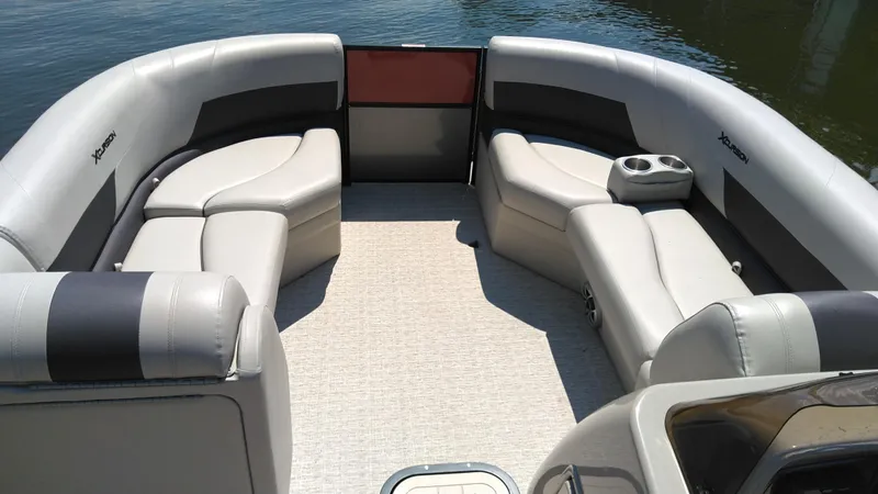 Slide: The Image of 2022 Xcursion 243RFX pontoon boat interior with plush seating and cup holders. - 3