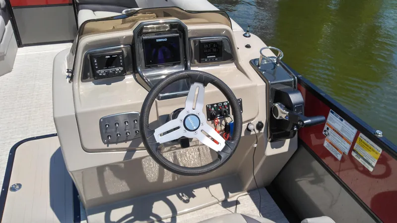 Slide: The Image of 2022 Xcursion 243RFX boat dashboard with steering wheel and control panel. - 6