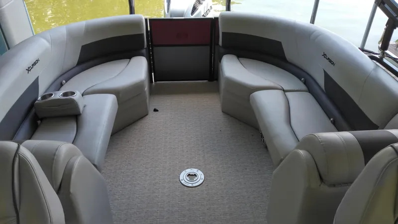 Slide: The Image of 2022 Xcursion 243RFX boat interior with gray seating and cup holders. - 8