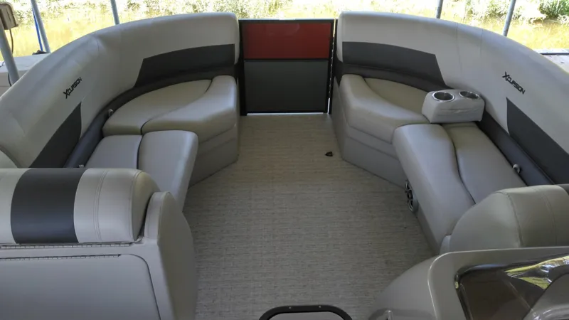 Slide: The Image of 2022 Xcursion 243RFX boat interior with gray seating and cup holders. - 9