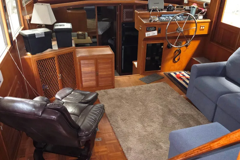 Slide: The Image of 1989 Marine Trader 47 CMY interior with helm, seating, and wooden cabinetry. - 12