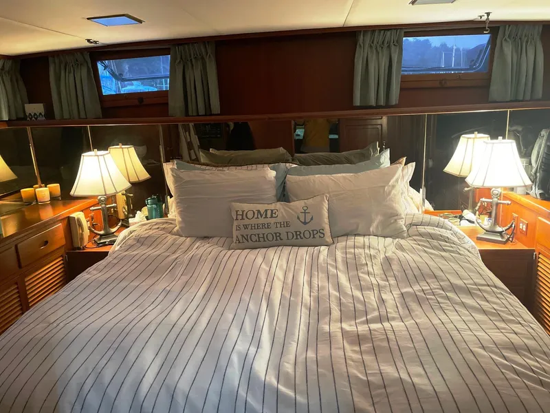 Slide: The Image of Cozy bedroom in 1989 Marine Trader 47 CMY yacht with nautical decor and ambient lighting. - 23