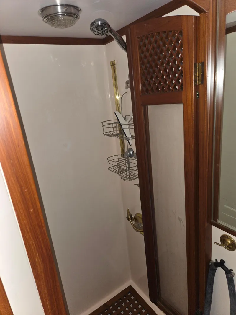 Slide: The Image of 1989 Marine Trader 47 CMY shower with wood accents and metal fixtures. - 26