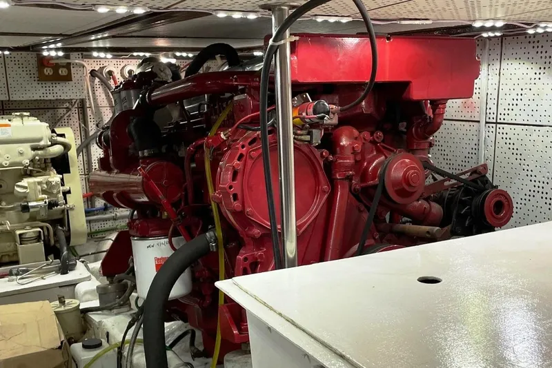 Slide: The Image of Engine room of 1989 Marine Trader 47 CMY with red machinery and equipment. - 29