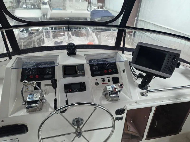 Slide: The Image of 1989 Marine Trader 47 CMY helm with navigation equipment and steering wheel. - 8