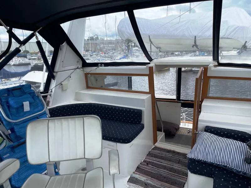 Slide: The Image of 1989 Marine Trader 47 CMY interior with seating, windows, and nautical decor. - 9