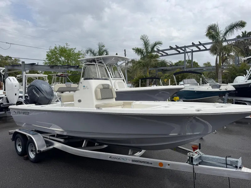 Slide: The Image of 2025 Key West 210 Bay Reef boat on trailer, parked outdoors. - 1