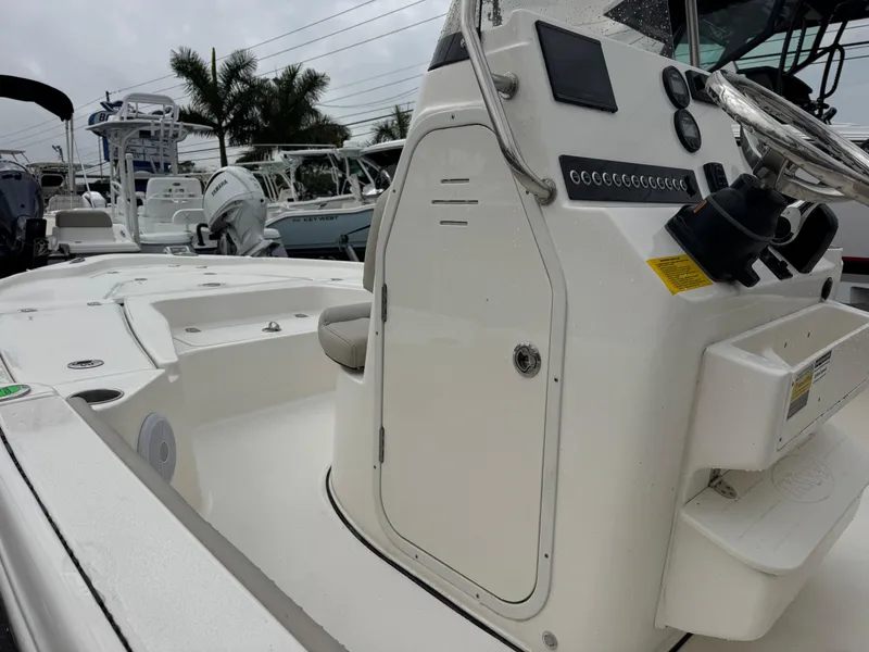 Slide: The Image of 2025 Key West 210 Bay Reef boat interior with steering console and seating. - 12