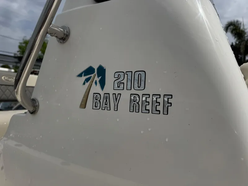 Slide: The Image of 2025 Key West 210 Bay Reef boat logo on white surface. - 18