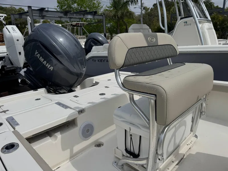 Slide: The Image of 2025 Key West 210 Bay Reef boat with Yamaha engine, featuring a cushioned seat and sleek design. - 19
