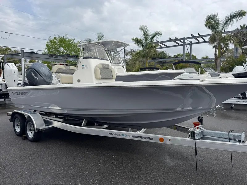 Slide: The Image of 2025 Key West 210 Bay Reef boat on trailer, parked outdoors. - 2
