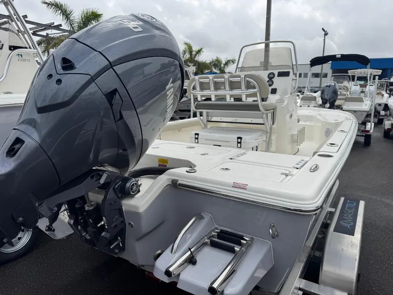 Slide: The Image of 2025 Key West 210 Bay Reef boat with powerful outboard motor, parked on trailer. - 5