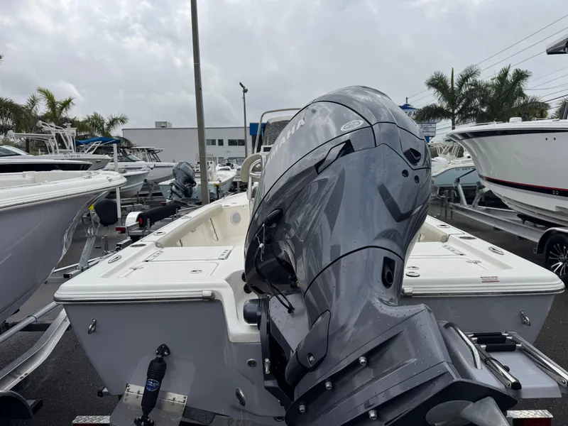 Slide: The Image of 2025 Key West 210 Bay Reef boat with powerful outboard motor, displayed in a marina. - 7