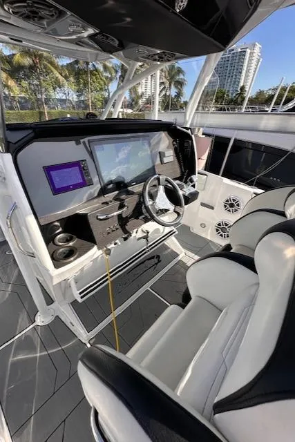 Slide: The Image of 2019 Nor-Tech 340 Sport Center Console interior with modern dashboard and seating. - 11