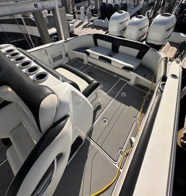 Slide: The Image of 2019 Nor-Tech 340 Sport Center Console boat interior with seating and multiple outboard engines. - 4