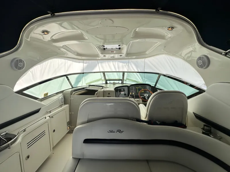 Slide: The Image of Interior view of 2007 Sea Ray 380 Sundancer yacht cockpit with white seating and dashboard. - 10